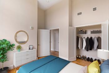 A bedroom with a bed and a closet